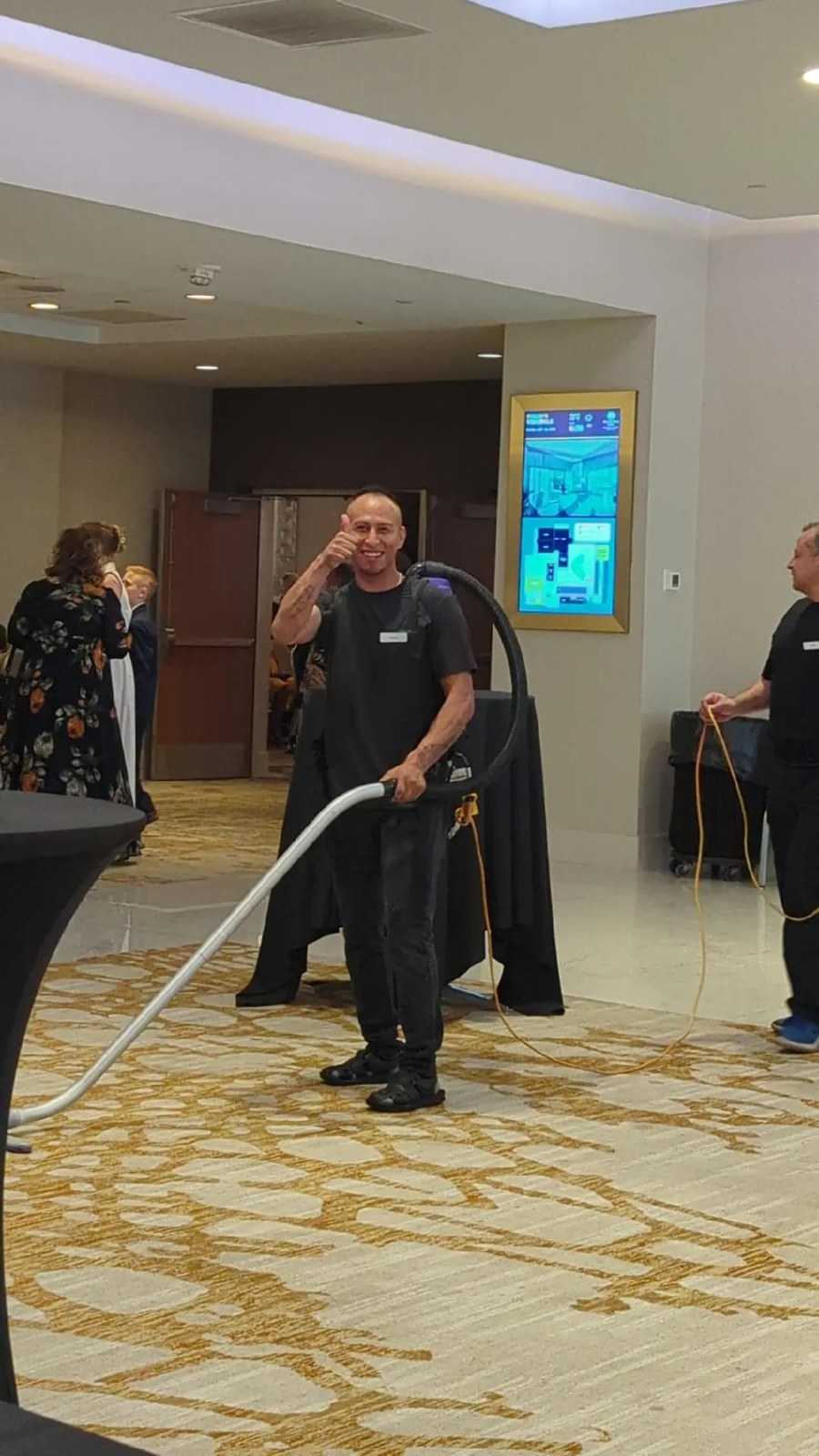 Montoya team member vacuuming a carpeted event space