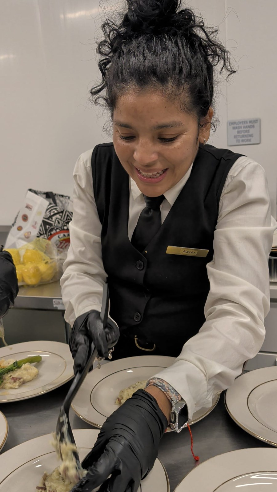 Montoya team member preparing plates for service