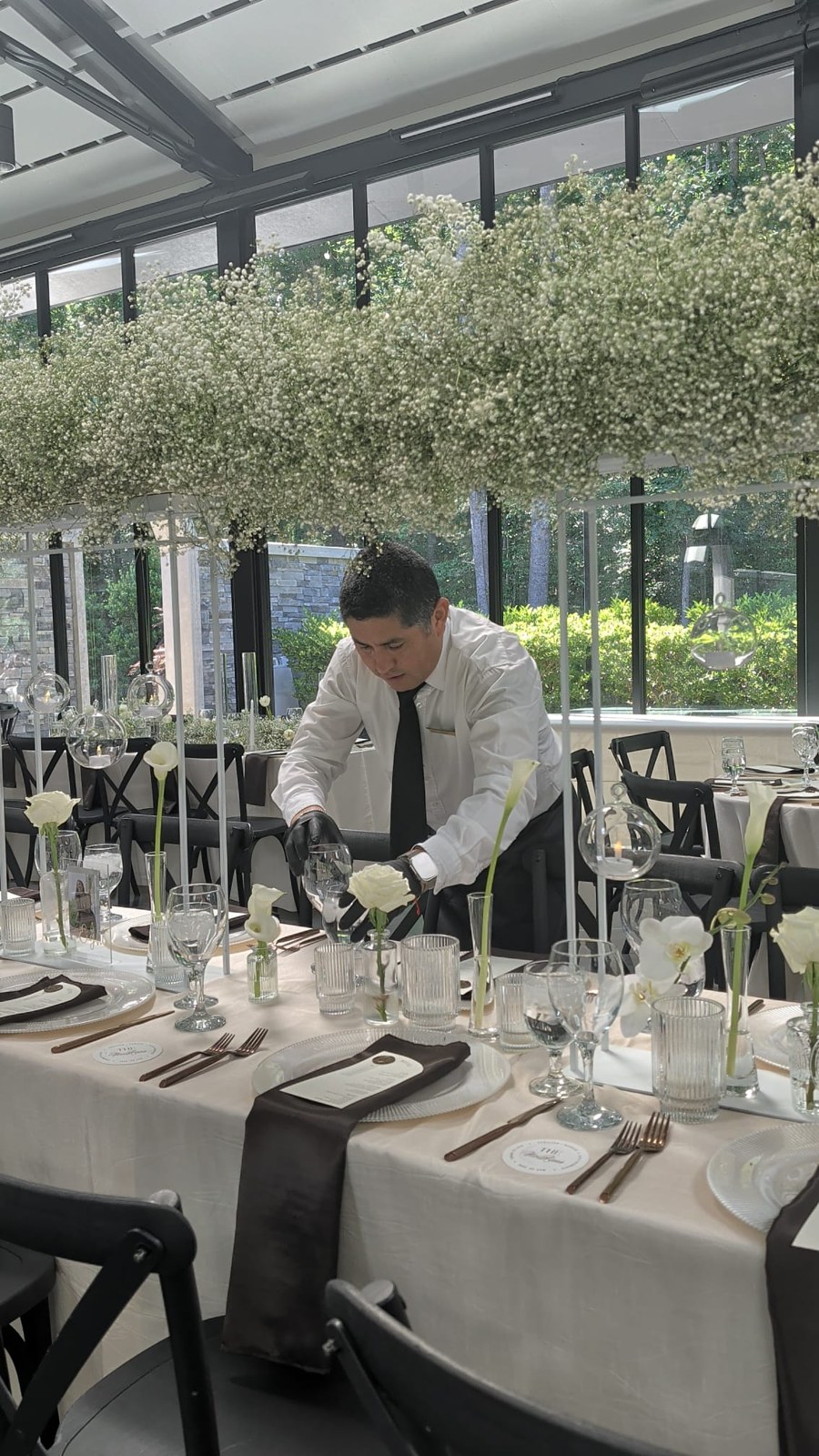 Montoya team member setting tables in an event venue